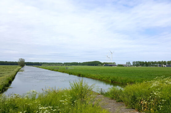 Polderlandschap met sloot en een windmolen, ruimte voor de energietransitie in de ruimtelijke ordening
